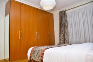 Built-in wooden wardrobe in a furnished 2-bedroom apartment at Lymack Suites, Fourways Junction near Kiambu Road