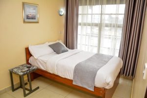 Bright bedroom with natural light in the Deluxe 1-Bedroom Furnished Apartment at The Moon Serenity Ruaka Branch