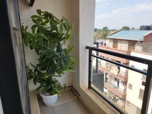 Private balcony at The Moon Serenity Ruaka Branch Deluxe 1-Bedroom Furnished Apartment with outdoor seating and neighborhood views