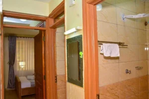 Hallway outside the bedroom and bathroom at The Moon Serenity Kalwani Park furnished apartment in Thindigua Nairobi