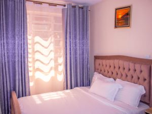 Elegant master bedroom at The Moon Serenity Furnished Apartments Thindigua Branch at Kalwani Park featuring a spacious modern layout, premium bedding, natural lighting, and executive furnished apartment décor.