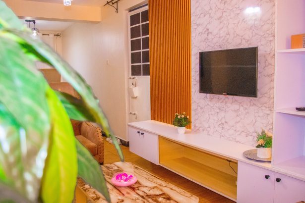 TV and lounge area inside The Moon Serenity Furnished Apartments Thindigua Branch, featuring a modern living room, comfortable seating, and stylish interior décor.