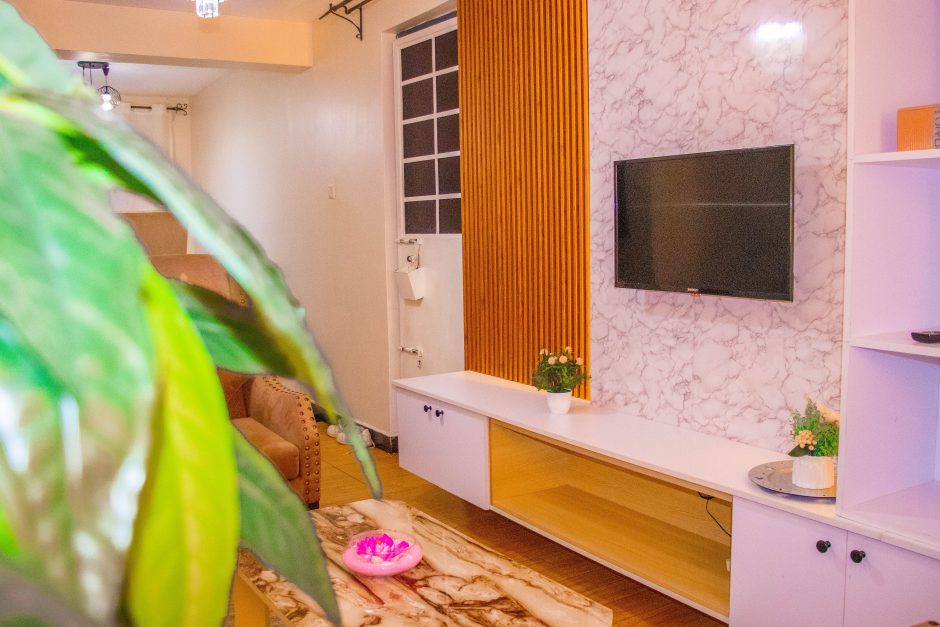 TV and lounge area inside The Moon Serenity Furnished Apartments Thindigua Branch, featuring a modern living room, comfortable seating, and stylish interior décor.