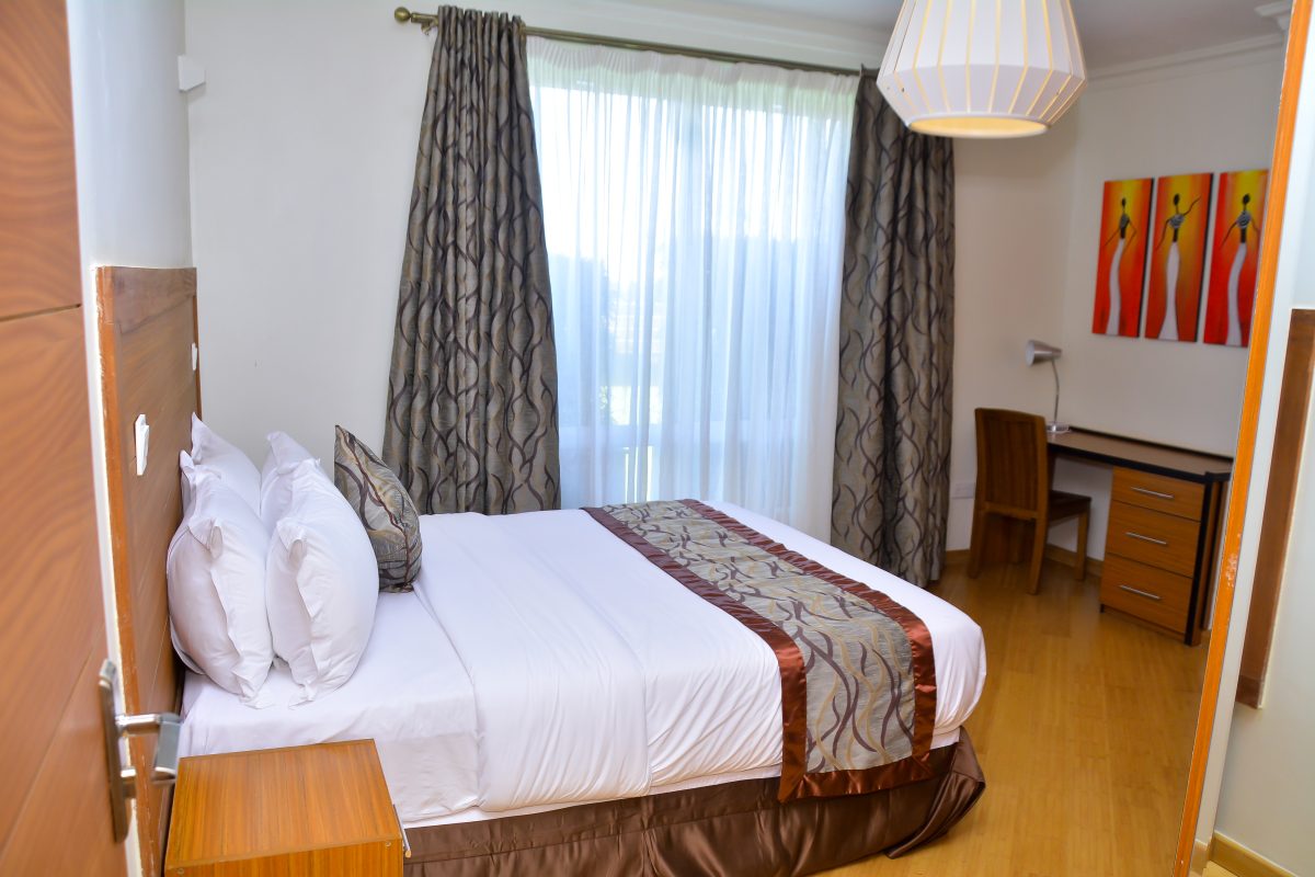 Cozy bedroom with a dedicated study table and workspace at The Moon Serenity Fourways Branch Off Kiambu Road, Nairobi.
