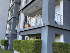 Private leafy balcony with outdoor seating at The Moon Serenity Fourways Branch, offering tranquil garden views and a relaxing retreat.