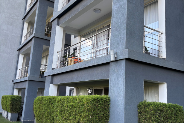 Private leafy balcony with outdoor seating at The Moon Serenity Fourways Branch, offering tranquil garden views and a relaxing retreat.