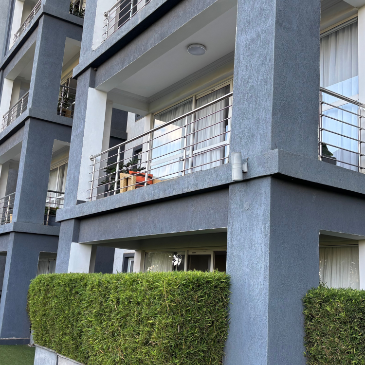 Private leafy balcony with outdoor seating at The Moon Serenity Fourways Branch, offering tranquil garden views and a relaxing retreat.